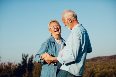 seniors with Hybrid Implant Dentures laughing and enjoying the beautiful outdoors