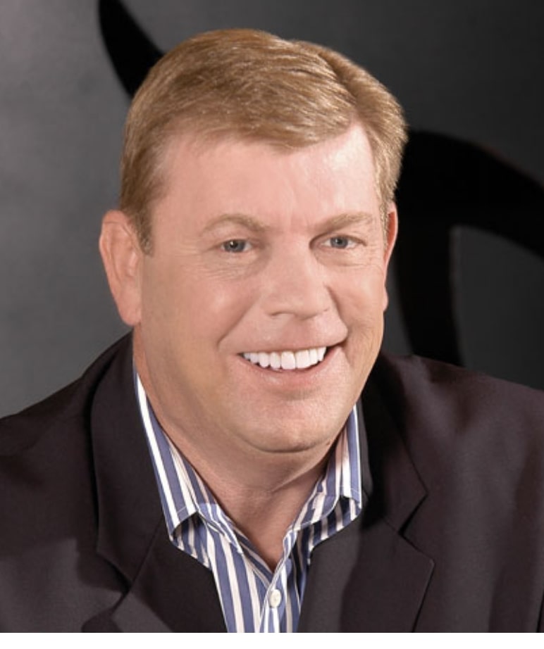 Happy gentleman wearing a suit with a broad smile thanks to his dentist
