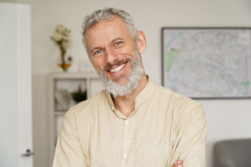 Man smiling in living room.