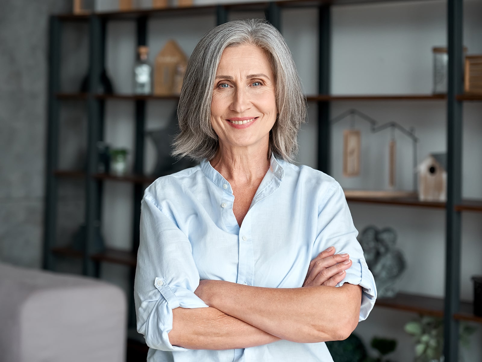 Mature woman smiling in living room-min Mature woman smiling in living room